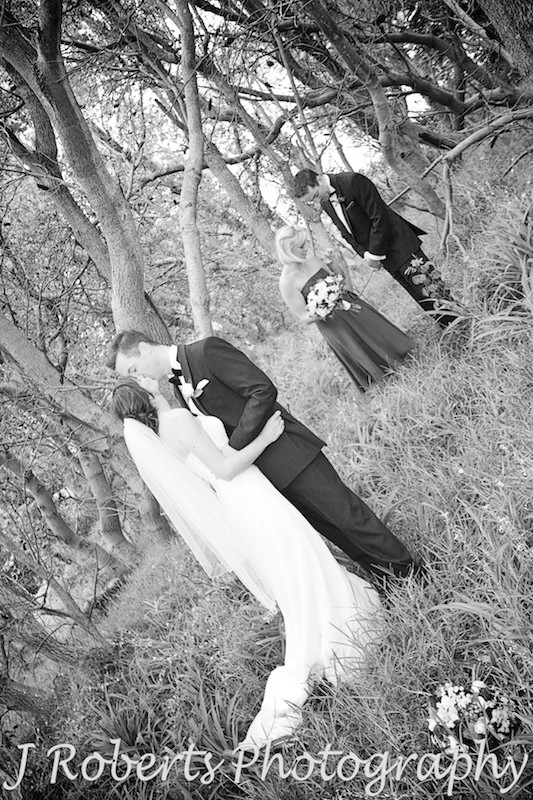 bride and groom kissing in the trees - wedding photography sydney